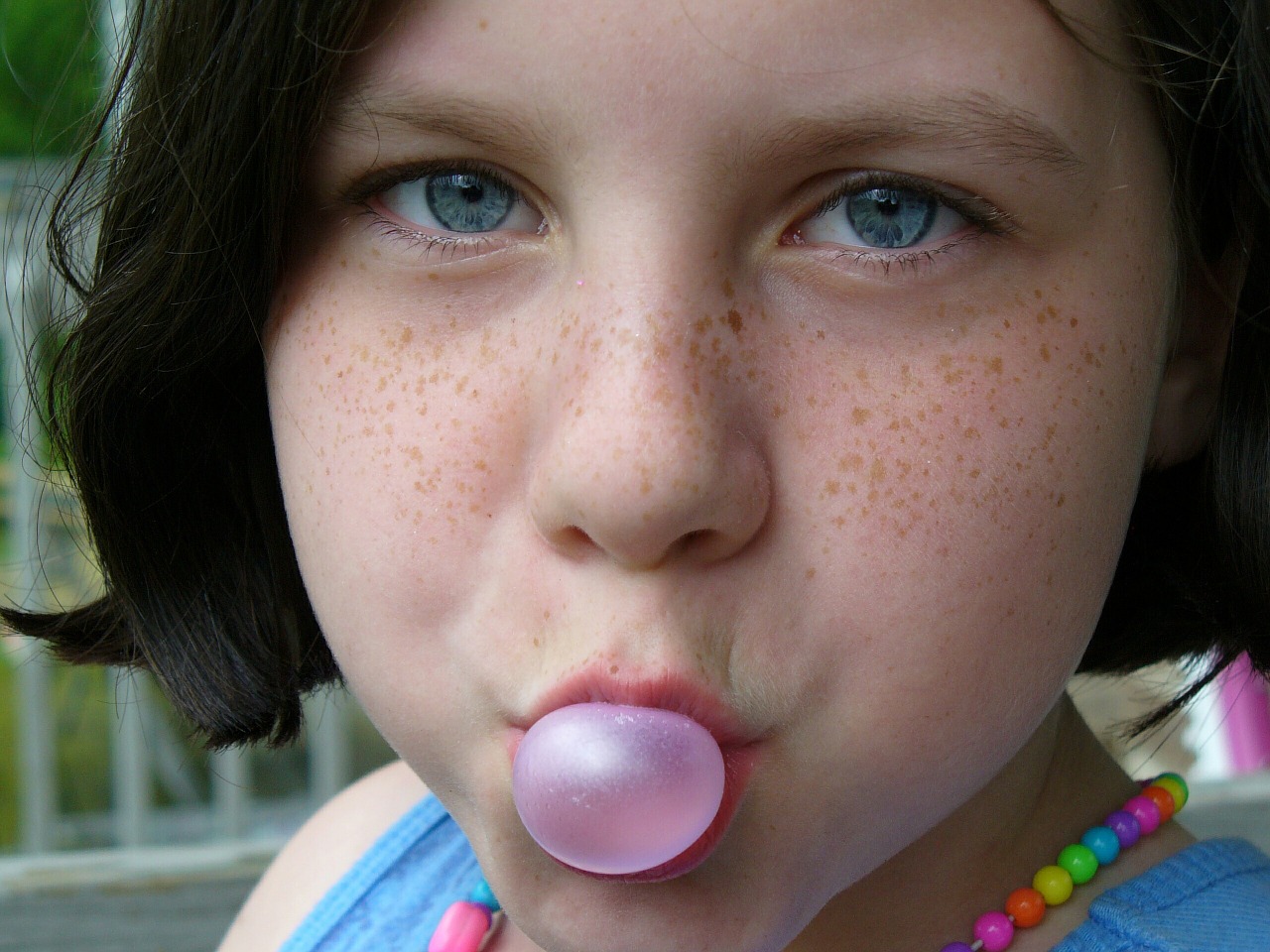 Girl blowing bubblegum bubble